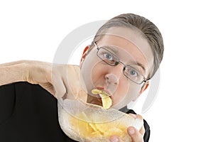 Man eating potato chips hurriedly
