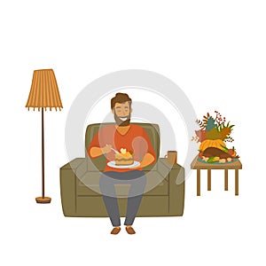 Man eating pumpkin pie sitting at home on a sofa