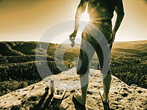 Man eating sandwich and apple while rest on rocky mountain photo