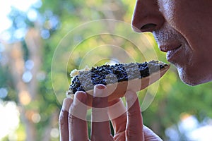 Man eating a sandwich with black caviar photo