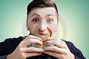 Man eating a sandwich with violent impetuosity