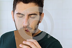 Man eats chocolate with great pleasure photo