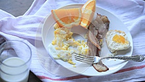 Man eats eggs and bacon breakfast