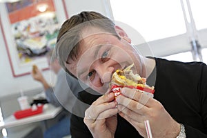 Man eats hamburger