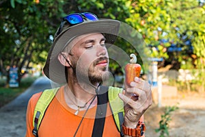 Man eats nuts isolated on a light background.nMan shows a set of nuts