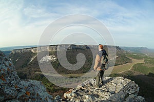 Man on the edge of a cliff in cave town Mangup-Kale