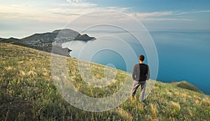 Man on the edge. Cliff of mountain and sea