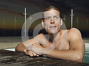 Man At The Edge Of Outdoor Pool At Dusk