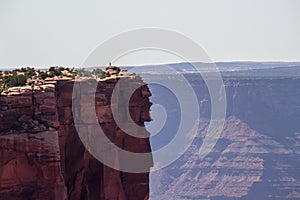 Man at the edge of the rock on the top of the canyon in Dead Horse Point State Park. Canyonlands, Utah