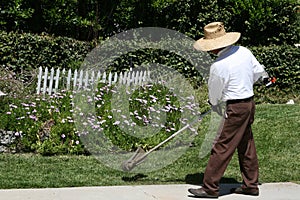 Man edging grass landscaping