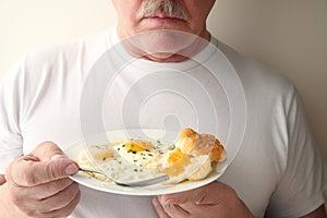 Man with eggs and biscuit breakfast