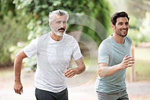 man and elderly man runner athlete running at park