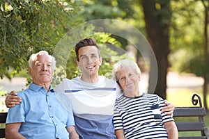 Man with elderly parents on bench