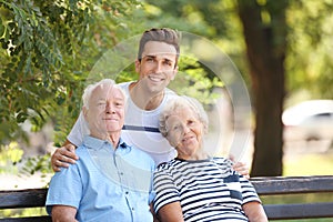 Man with elderly parents in park