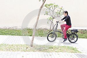 Man on electric bicycle going up hill in medellin