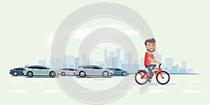 Man on Electric Bicycle on the Street with Cars behind