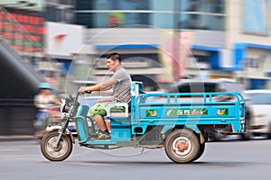 Man on an electric freight bike in Beijing downtown, China