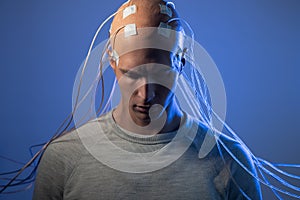 Man with electrodes in his head is a futuristic concept of virtual reality and mind control.