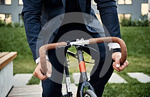 Man in elegant suit riding bicycle. Business man on a bicycle