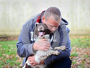 Man embracing his dog