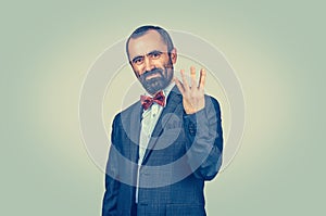 Man, employee giving four fingers gesture with hand