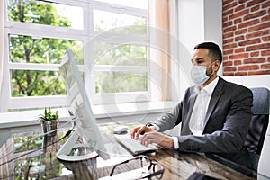 Man Employee In Office Wearing Face Mask Working