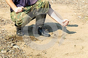 Man empties a squeak from his palm. Drought photo