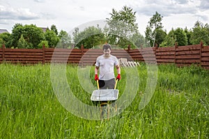 Man with empty wheelbarrow in the grass