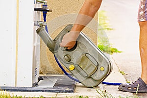 Man emptying caravan tank toilet cassette in dump station