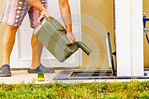 Man emptying caravan tank toilet cassette in dump station