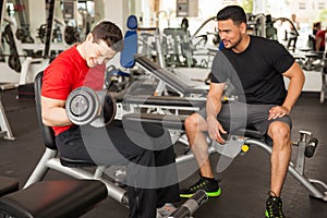 Man encouraging his friend at the gym