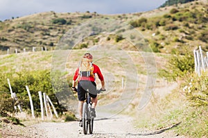 Man enduro mountain biking on country road