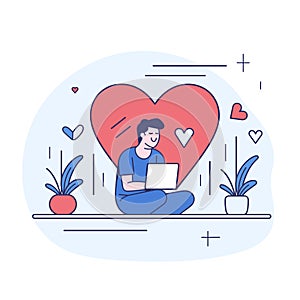 Man engaged online dating, sitting crosslegged laptop, large heart backdrop. Male figure photo