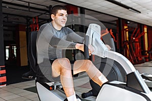 A man engaged in training on a sports bike in the gym, morning training