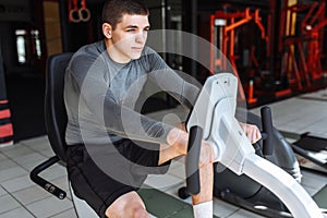 A man engaged in training on a sports bike in the gym, morning training