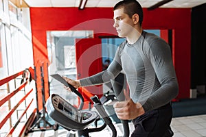 A man engaged in training on a sports bike in the gym, morning training