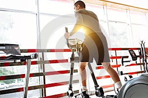 A man engaged in training on a sports bike in the gym, morning training