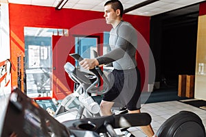 A man engaged in training on a sports bike in the gym, morning training