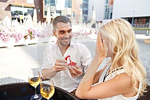 Man with engagement ring making proposal to woman