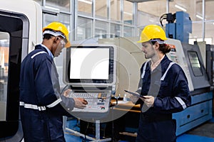 Man engineer using computer blank white screen controlling cnc machine at workshop. Male control automated machine process