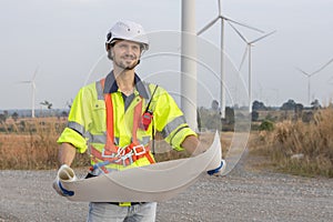 man engineer worker wearing safety uniform holding and reading blueprint working about renewable energy at station energy power