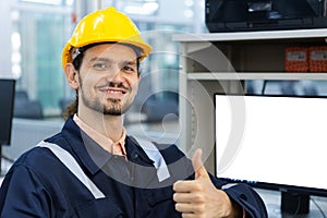 man engineering smiling thumb up with computer white screen. Cnc machine at workshop. Male control automated machine process