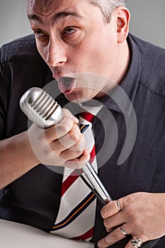 Man engrossed in his music holding a microphone