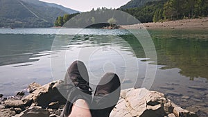 Man enjoy relax at tranquil lake pov shot of shoes background