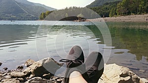 Man enjoy relax at tranquil lake pov shot of shoes panning background