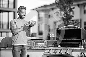 Man enjoying barbecuing. man grilling his favorite meats. cook showcasing his barbecue techniques at cookout event, copy photo