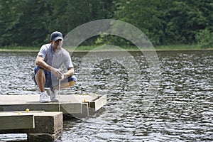 Man enjoying a beautiful day on the lake fishing photo