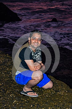 Man enjoying Evening at Tanha Lot, Bali Indonesia, Portrait of a Indian man at Beautiful Tanha lot beach in the evening at Bali