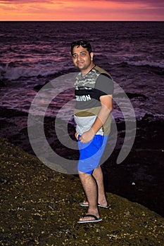 Man enjoying Evening at Tanha Lot, Bali Indonesia, Portrait of a Indian man at Beautiful Tanha lot beach in the evening at Bali