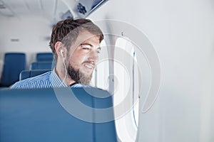 Man enjoying his journey by airplane